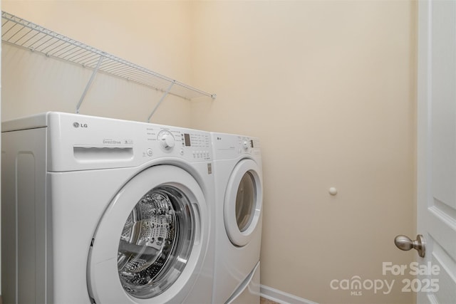 laundry area featuring washing machine and clothes dryer