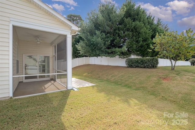 view of yard featuring ceiling fan, a patio area, and a sunroom