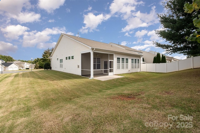 back of house with a lawn and a sunroom