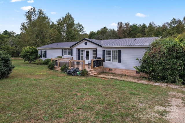 back of house featuring a wooden deck and a lawn