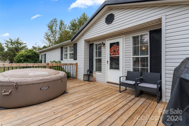 deck featuring a hot tub