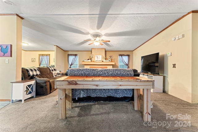 recreation room featuring ornamental molding, ceiling fan, a textured ceiling, and light colored carpet