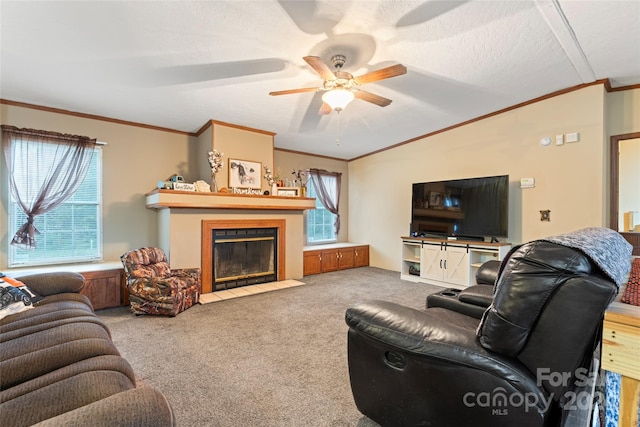 carpeted living room featuring ceiling fan, a textured ceiling, a wealth of natural light, and ornamental molding