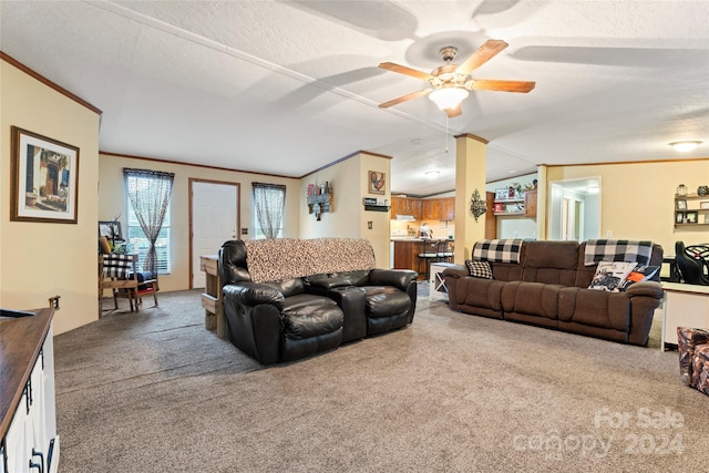 carpeted living room featuring ornamental molding, a textured ceiling, lofted ceiling, and ceiling fan