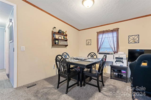 dining space featuring ornamental molding, carpet, vaulted ceiling, and a textured ceiling