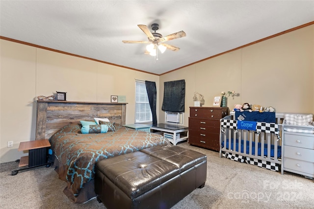 bedroom featuring ceiling fan, carpet flooring, lofted ceiling, and ornamental molding