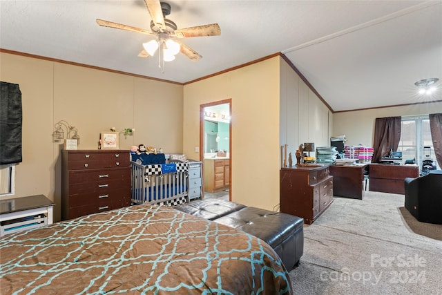 carpeted bedroom featuring ensuite bath, crown molding, vaulted ceiling, and ceiling fan