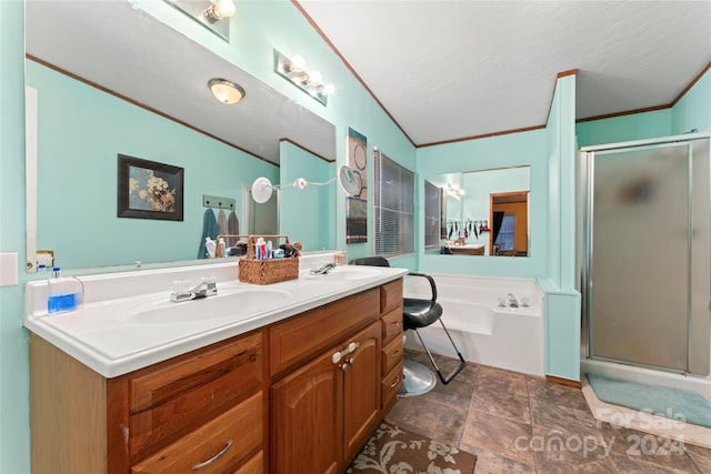 bathroom featuring lofted ceiling, separate shower and tub, a textured ceiling, ornamental molding, and vanity