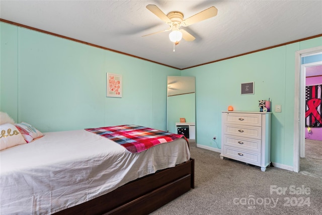 carpeted bedroom with ornamental molding, a textured ceiling, and ceiling fan