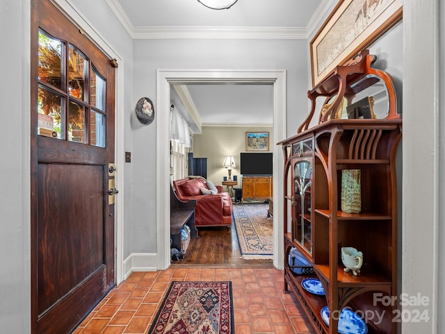 entrance foyer with ornamental molding and hardwood / wood-style floors