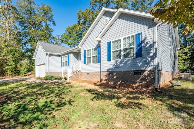 view of front facade with cooling unit, a garage, and a front yard