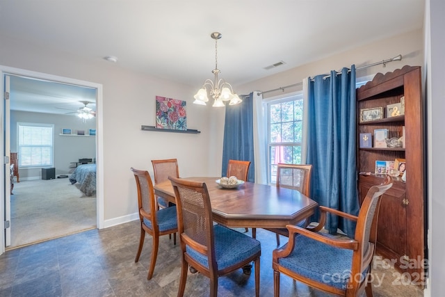 dining room with a wealth of natural light, visible vents, baseboards, and dark carpet