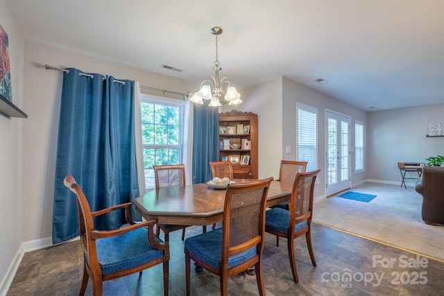 dining area with visible vents, baseboards, and a notable chandelier