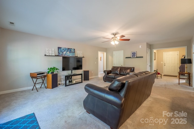 living area with light carpet, visible vents, a ceiling fan, and baseboards