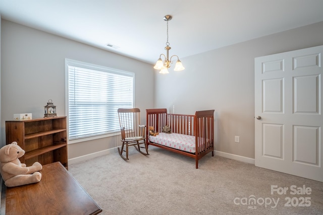 bedroom with baseboards, light colored carpet, visible vents, and a chandelier