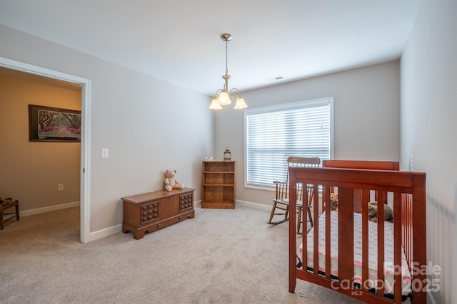 carpeted bedroom featuring an inviting chandelier, baseboards, and visible vents