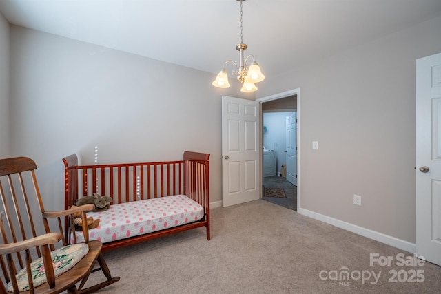 carpeted bedroom with baseboards and an inviting chandelier