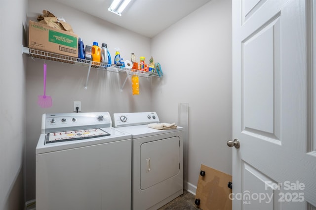 laundry area featuring washing machine and clothes dryer and laundry area