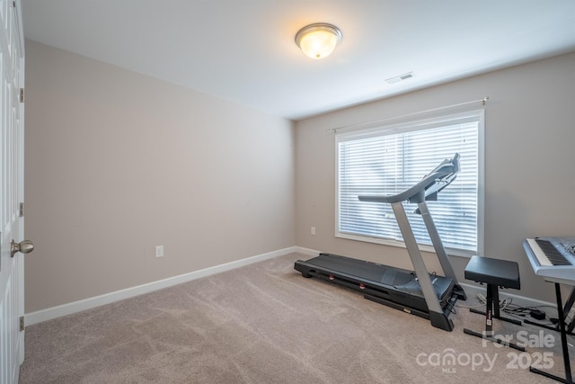 workout area with visible vents, baseboards, and carpet