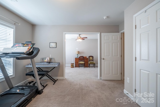 workout area with a ceiling fan, carpet, baseboards, and a wealth of natural light