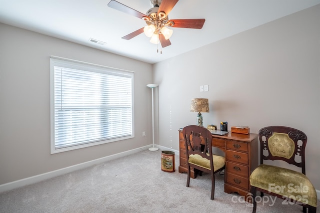 carpeted office space with a ceiling fan, baseboards, and visible vents