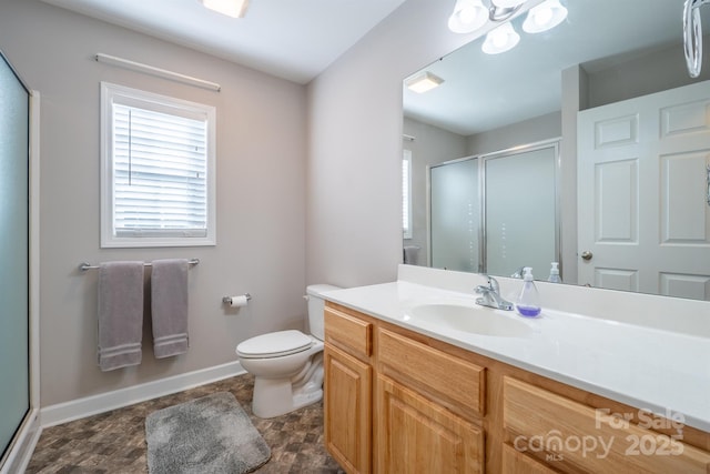 bathroom with visible vents, toilet, a stall shower, baseboards, and vanity