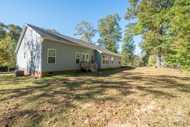 rear view of property with crawl space, a lawn, and central AC