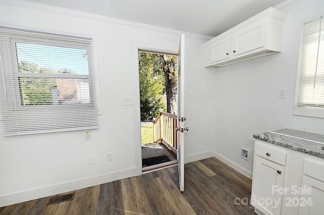 doorway to outside featuring crown molding and dark wood-type flooring