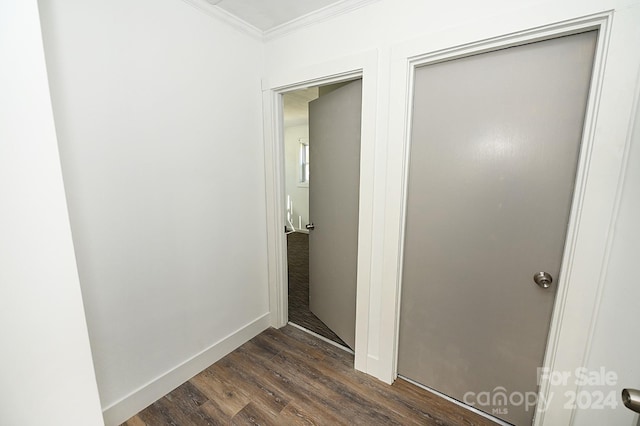 corridor with crown molding and dark wood-type flooring