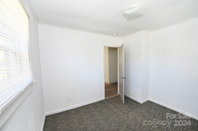 carpeted empty room featuring ornamental molding