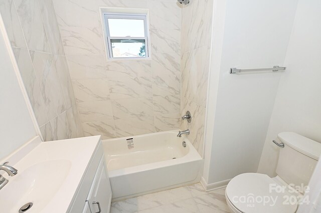 full bathroom featuring vanity, tiled shower / bath combo, and toilet