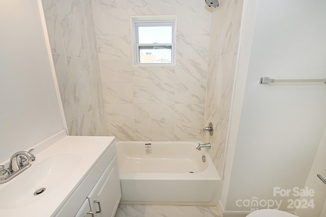 full bathroom featuring vanity, tiled shower / bath combo, and toilet