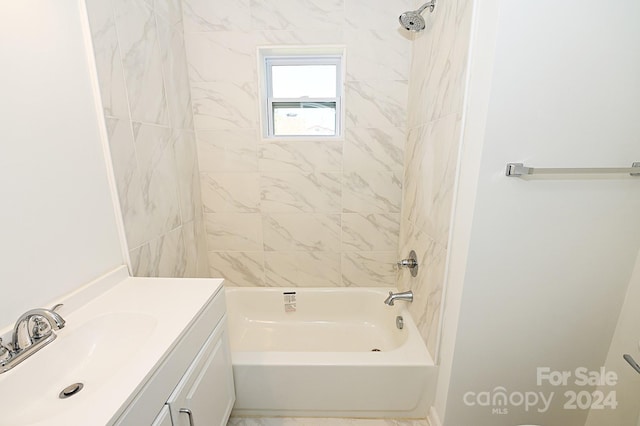 bathroom featuring vanity and tiled shower / bath