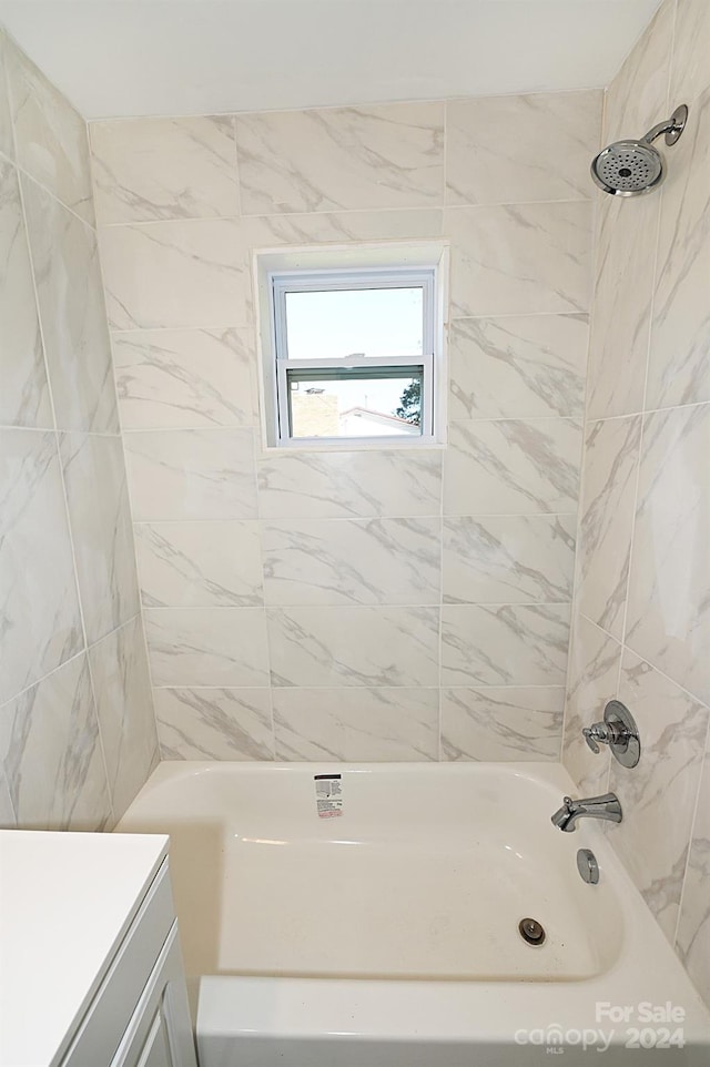 bathroom with vanity and tiled shower / bath combo