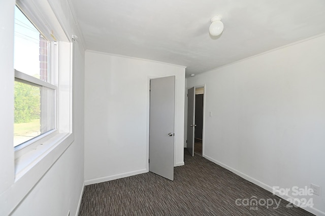 unfurnished bedroom with dark colored carpet