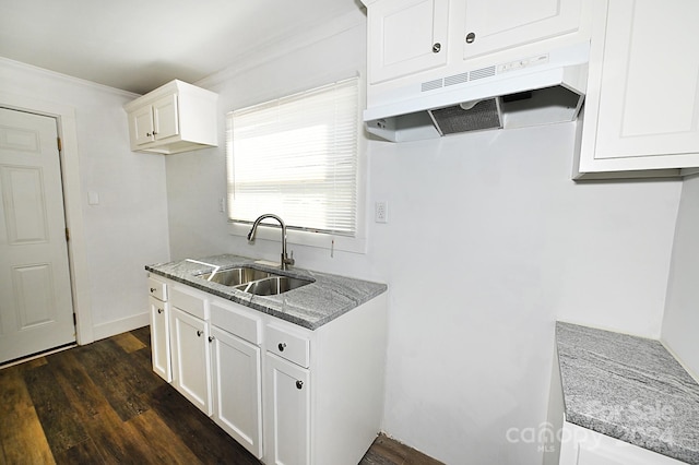 kitchen featuring stone countertops, ornamental molding, sink, white cabinets, and dark hardwood / wood-style flooring