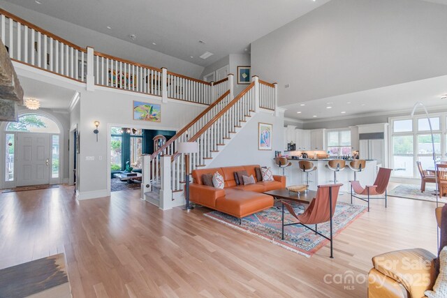 18212 Pompano Pl, Cornelius, NC 28031 - living area with a towering ceiling, light wood-style floors, plenty of natural light, and baseboards