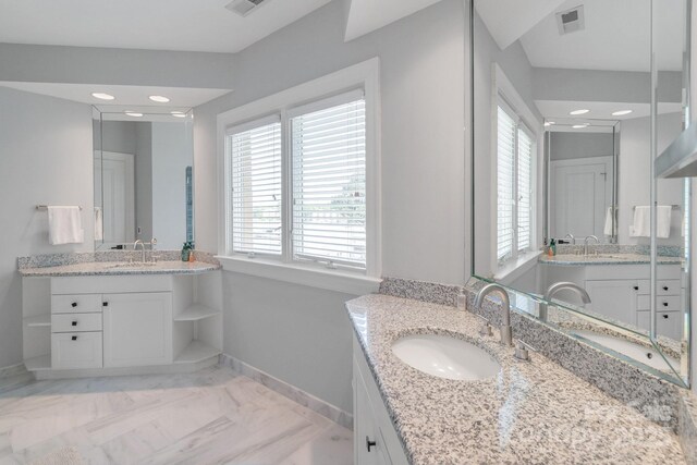 18212 Pompano Pl, Cornelius, NC 28031 - bathroom with baseboards, two vanities, marble look tiles, and recessed lighting