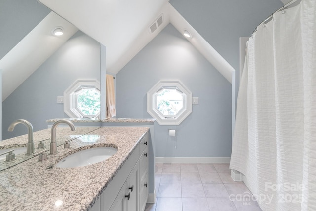 18212 Pompano Pl, Cornelius, NC 28031 - bathroom featuring vaulted ceiling, vanity, and baseboards