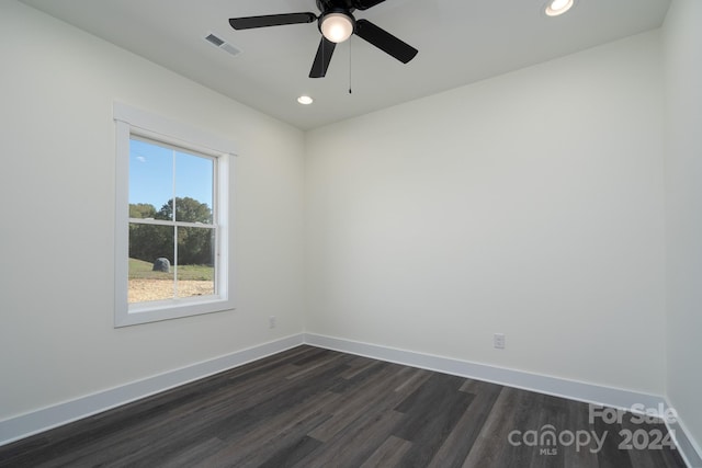 spare room featuring ceiling fan and dark hardwood / wood-style floors