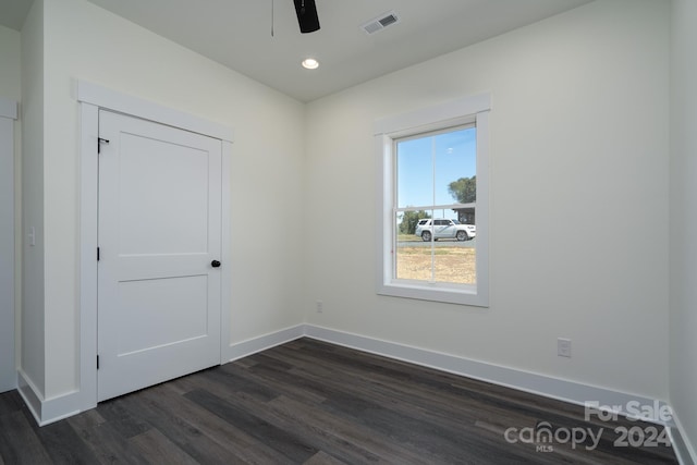 spare room featuring ceiling fan and dark hardwood / wood-style floors