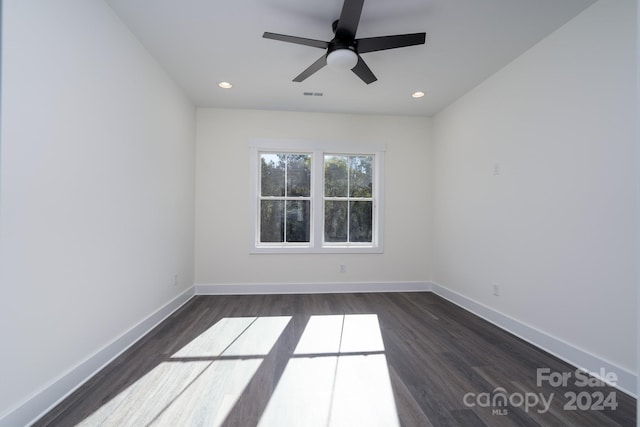 empty room featuring dark wood-type flooring and ceiling fan