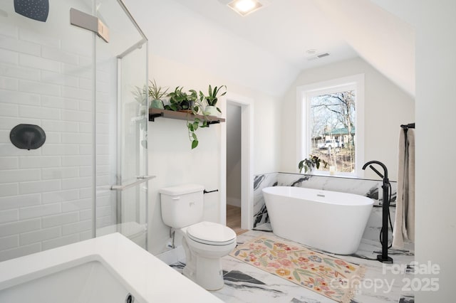 bathroom with toilet, shower with separate bathtub, and vaulted ceiling