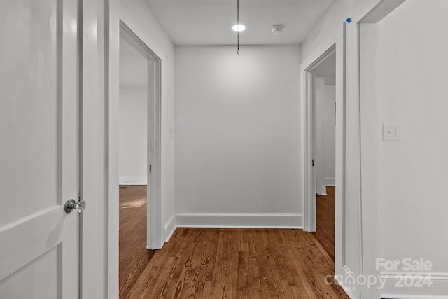 hallway with hardwood / wood-style floors