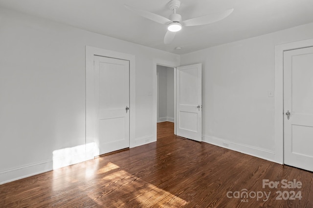 unfurnished room with ceiling fan and dark hardwood / wood-style flooring