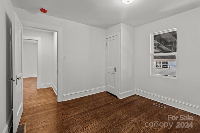 empty room with dark hardwood / wood-style floors