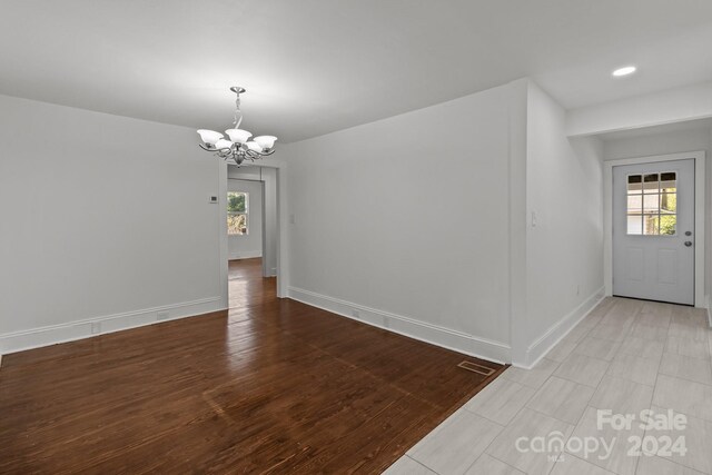 interior space featuring light hardwood / wood-style flooring and a chandelier