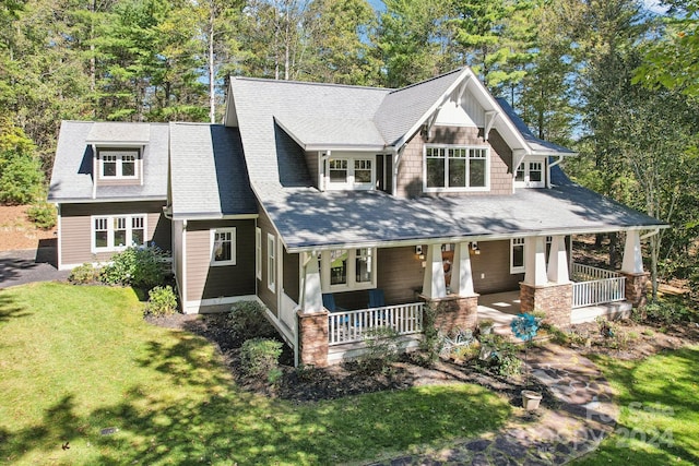 craftsman-style house with a front lawn and covered porch