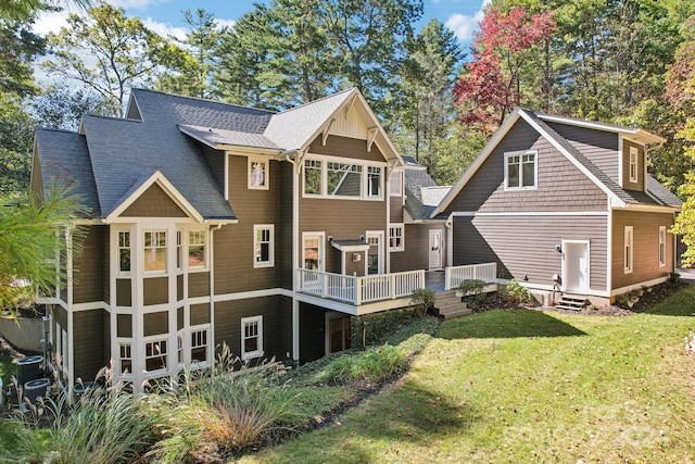 rear view of property featuring a yard