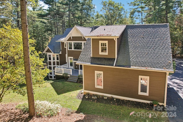 rear view of property featuring a lawn